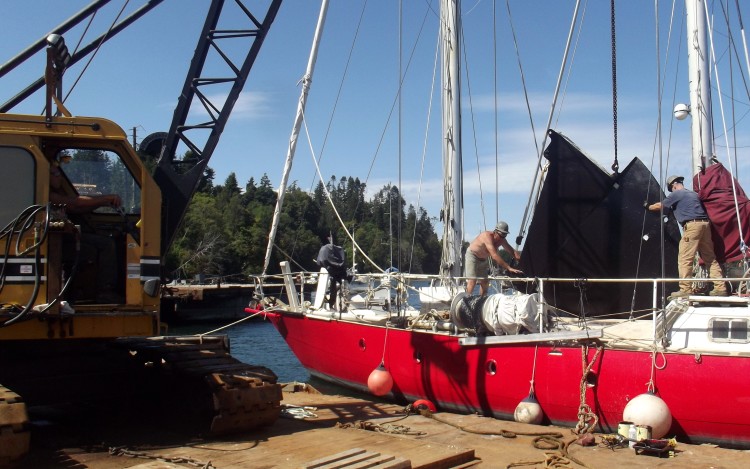 Lifting centerboard out of boat, pic from beside boat